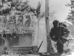 A SEAL scans the surroundings during his unit's intelligence-gathering mission in a Mekong Delta village.